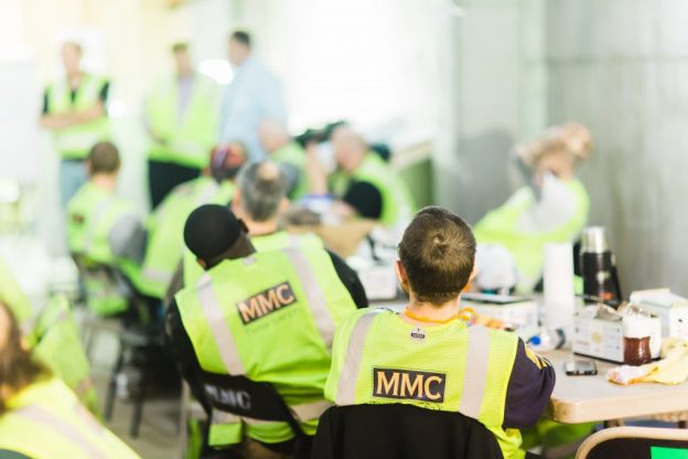 Employees/talent listening to leadership in break room