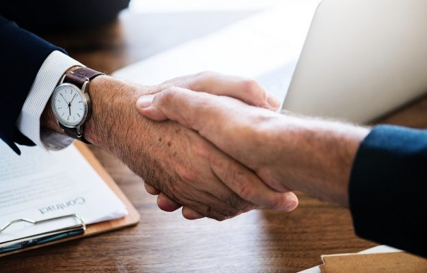 men shaking hands at business meeting